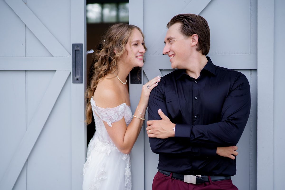 Couple at white barn doors
