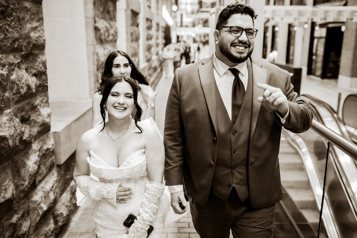 Newlyweds walking down stone steps